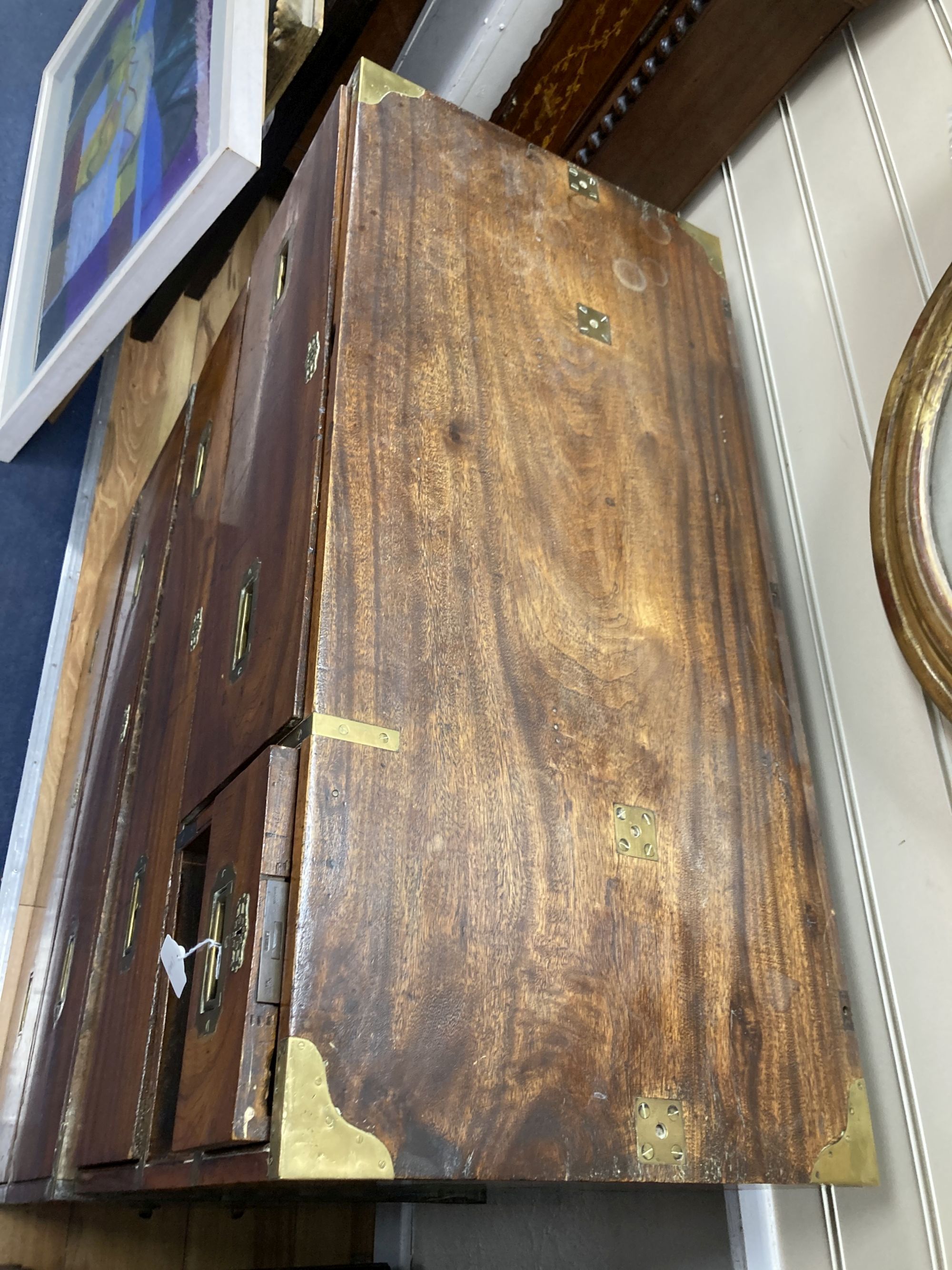 A 19th century brass mounted teak two part military chest (lacking one drawer) width 97cm, depth 46cm, height 107cm